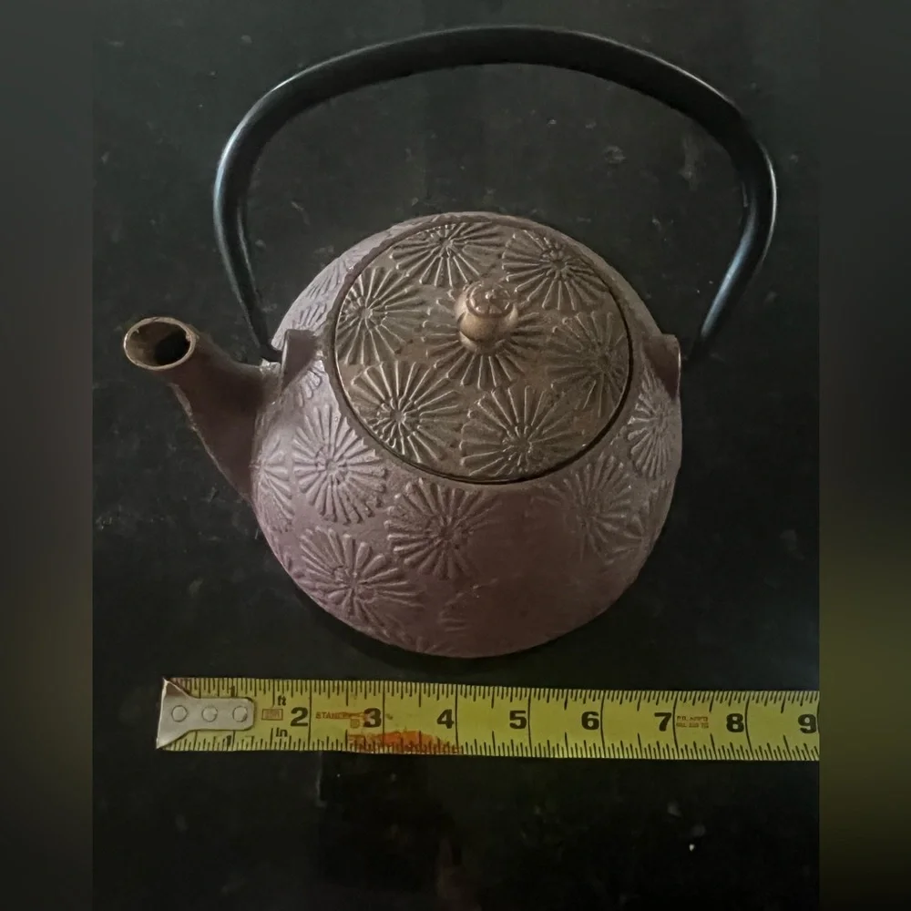 Cast iron tea pot with sunburst design